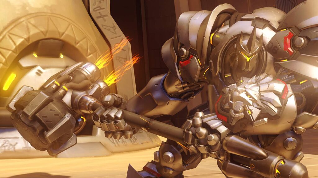 Reinhardt з Overwatch у бойовій броні, розмахуючи своєю ракетною молоткою, в храмоподібному середовищі.